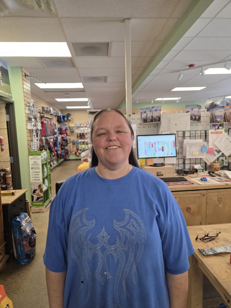 Smiling person in a pet store.